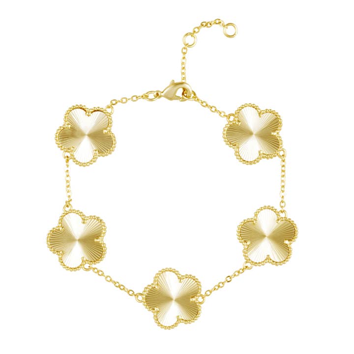 Gold bracelet with floral designs on a white background